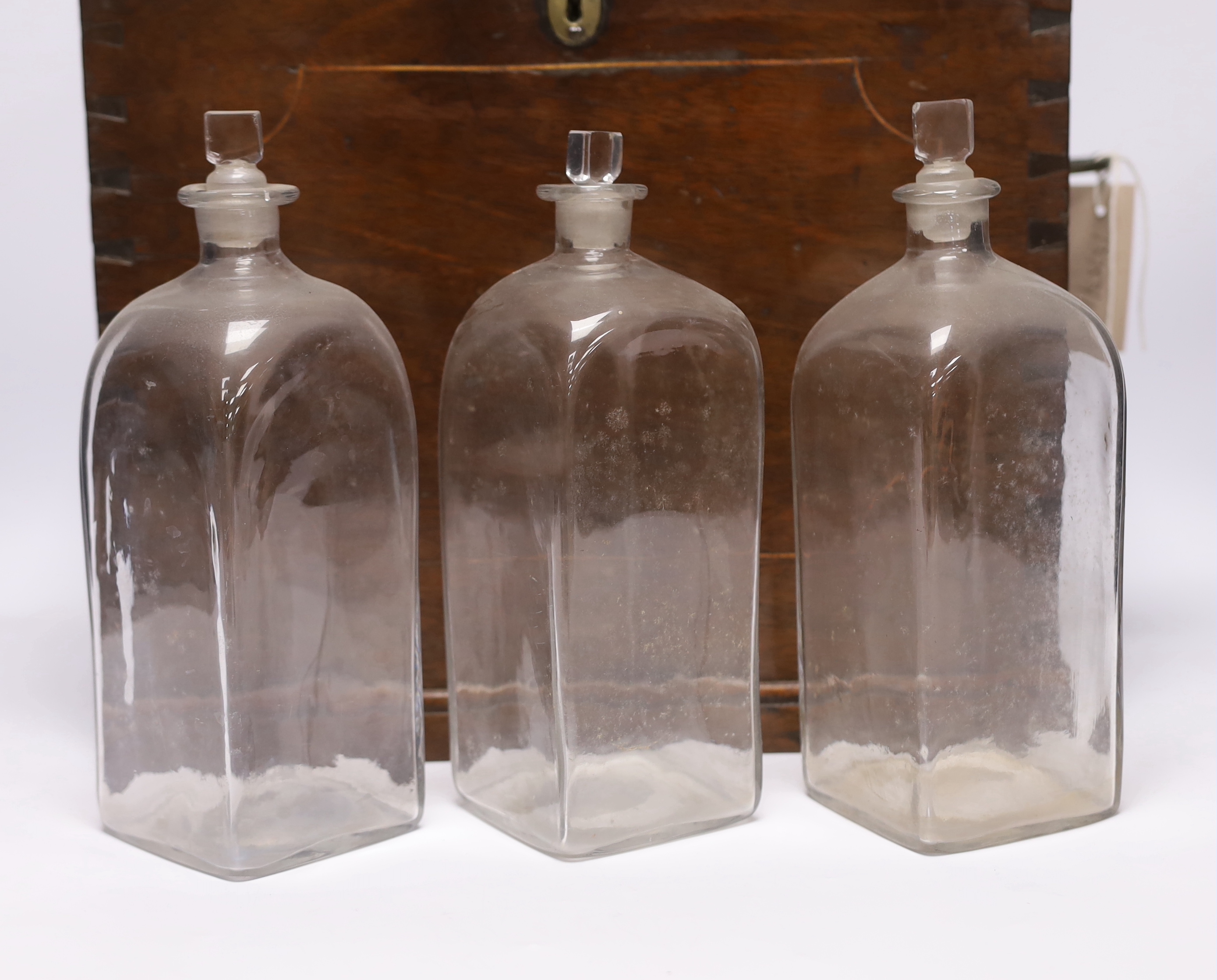 A Georgian mahogany decanter box, fitted six original plain glass decanters and stoppers, hinged lid and twin brass carrying handles, width 39cm